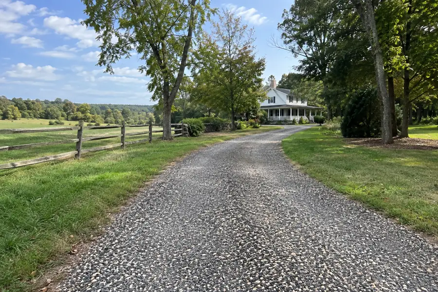 Tar and chip driveway with a textured crushed stone surface.